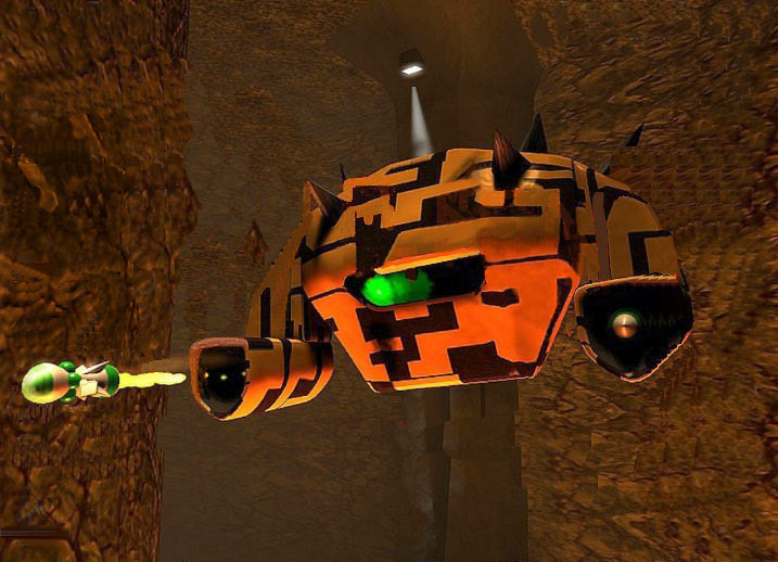 A large orange robot fires a missile in a rock cave